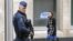 FILE - A Belgian police officer secures the area around the European Council headquarters.