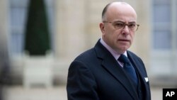 FILE - Then-French Interior minister Bernard Cazeneuve gives a press conference at the Elysee Palace.