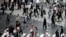 People walk on pedestrian crossings, July 17, 2020, at Tokyo's Shibuya district