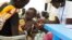 FILE - A child with suspected malnutrition is examined at a nutrition program clinic in Malakal, South Sudan, July 25, 2014. Chris Hillbruner of FEWSNET, a famine early warning system, said at the time that South Sudan was experiencing "the worst food security emergency in the world."