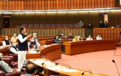 FILE - In this photo released by the Press Information Department, Pakistani Prime Minister addresses the Parliament in Islamabad, June 25, 2020. Khan accused the US of having 'martyred' al-Qaida leader Osama bin Laden.