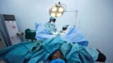 FILE - Doctors perform a fistula repair surgery on a patient in Maiduguri, Nigeria, July 31, 2018. Australian surgeon Dr. Andrew Browning has been performing similar procedures on women and girls in South Sudan.