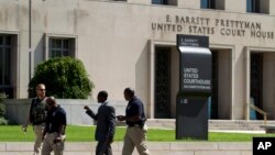 FILE - U.S. Marshals move outside of the federal U.S. District Court in Washington, D.C., June 28, 2014.