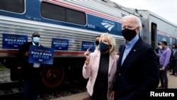 U.S. Democratic presidential candidate and former Vice President Joe Biden and his wife Jill greet supporters as they prepare to board an Amtrak train to begin a campaign train tour in Cleveland, Ohio, Sept. 30, 2020.