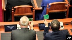 FILE — Lawmakers of the ruling Socialist party vote in Tirana, Albania, Thursday, Feb. 22, 2024.