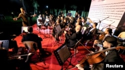 Chief Principal Conductor Karim Wasfi leads the Iraqi National Symphony Orchestra during a concert in Mosul, Oct. 27, 2018. 