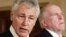 U.S. President Barack Obama's nominee for Secretary of Defense, former Senator Chuck Hagel (L), stands next to counterterrorism adviser John Brennan (R), the nominee for CIA Director at the White House, January 7, 2013. 