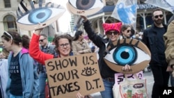 Demonstrators participate in a march and rally to demand President Donald Trump release his tax returns, April 15, 2017, in New York.