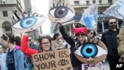 Demonstrators participate in a march and rally to demand President Donald Trump release his tax returns, April 15, 2017, in New York.