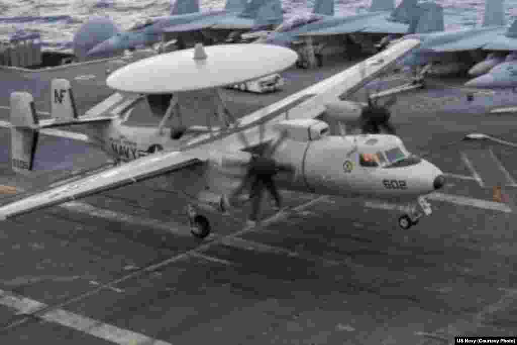 An E-2C Hawkeye from the Liberty Bells of Airborne Early Warning Squadron (VAW) 115 prepares to land on the flight deck of the aircraft carrier USS George Washington, Sept. 20, 2014.