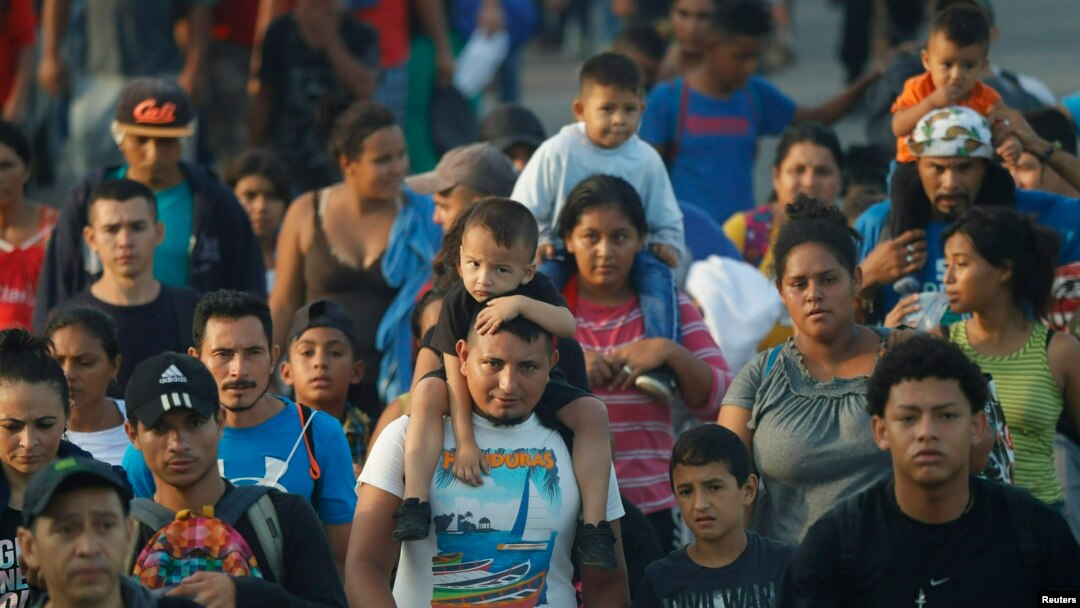 FILE - Hundreds of Central American migrants walk together on the highway, after crossing the Guatemala-Mexico border, near Ciudad Hidalgo, Mexico, June 5, 2019.