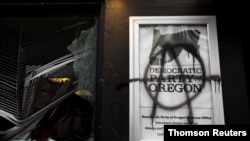 The Democratic Party of Oregon headquarters is vandalized during a protest after the inauguration of US President Joe Biden, in Portland, Oregon.