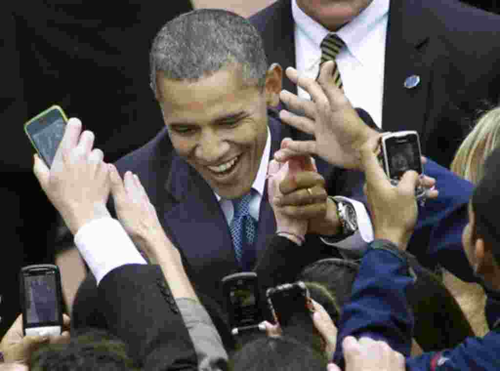 President Barack Obama shakes hands with supporters at Husky Stadium, on the University of Washington campus in Seattle, Thursday, Oct. 21, 2010. Obama spoke to the overflow crowd at the stadium before going next door to a basketball arena for a rally for