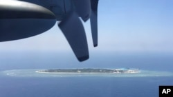 FILE - In this March 23, 2016, file photo, an aerial view is seen from a military plane carrying international journalists of the Taiwan-controlled Taiping island, also known as Itu Aba, in the Spratly archipelago, roughly 1600 kms. (1000 miles) in the So