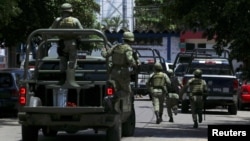 Soldiers arrive to the police headquarters during an operation to check if there are police officers that colluded with organized crime, in Acapulco, Mexico, Sept. 25, 2018. 