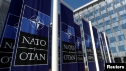 FILE PHOTO: Banners displaying the NATO logo are placed at the entrance of new NATO headquarters during the move to the new building