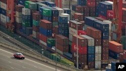 FILE - Shipping containers are seen at a port of Kwai Tsing Container Terminals in Hong Kong, Friday, Nov. 5, 2021. The United States accused China in a report Wednesday, Feb. 16, 2022, of failing to meet its commitments to the World Trade Organization.