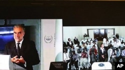 This composite view during a live video conference on March 14, 2011, shows International Criminal Court Prosecutor Luis Moreno Ocampo, left, as he speaks from The Hague, Netherlands, with a group of Kenyan journalists in Nairobi, Kenya