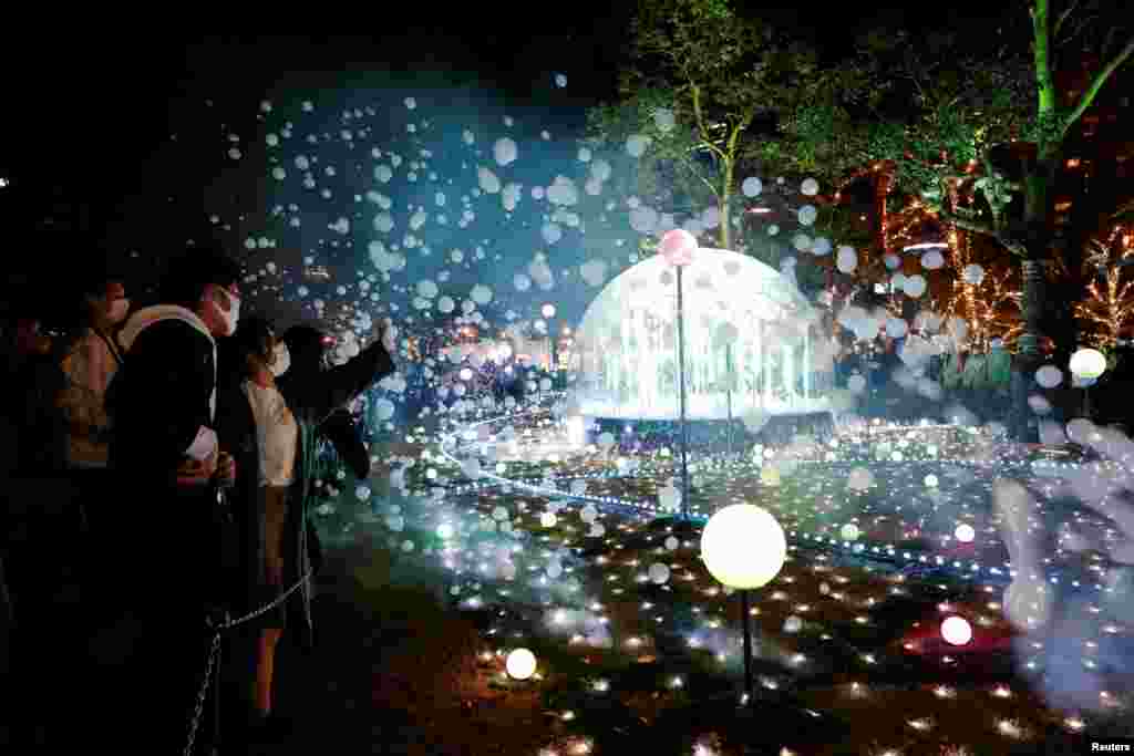 People take photos of Christmas illuminations in Tokyo, Japan, Nov. 23, 2021.