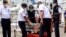 Members of National Transportation Safety Committee carry a box containing the cockpit voice recorder of Sriwijaya Air flight SJ-182 that crashed in January, after a press conference at Tanjung Priok Port in Jakarta, Indonesia, March 31, 2021.