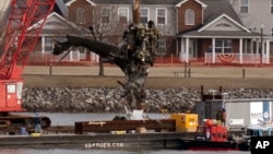 Salvage crews pull up a part of a Black Hawk helicopter near the site of a Jan. 29, 2025, mid-air collision between an American Airlines jet and a Black Hawk helicopter at Ronald Reagan Washington National Airport in Arlington, Virginia, Feb. 6, 2025.