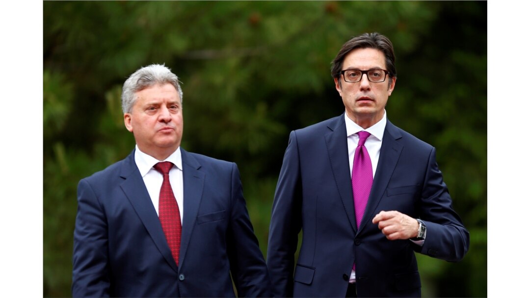 FILE - Newly elected President of North Macedonia Stevo Pendarovski, right, walks with outgoing president Gjorge Ivanov, during his inauguration ceremony in Skopje, North Macedonia, May 12, 2019.