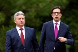 FILE - Newly elected President of North Macedonia Stevo Pendarovski, right, walks with outgoing president Gjorge Ivanov, during his inauguration ceremony in Skopje, North Macedonia, May 12, 2019.