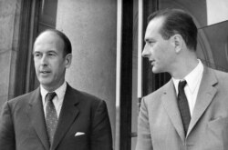 FILE - Valery Giscard d'Estaing, left, as finance minister and Jacques Chirac as secretary of state to finance leave Elysee Palace, Aug. 9, 1969.