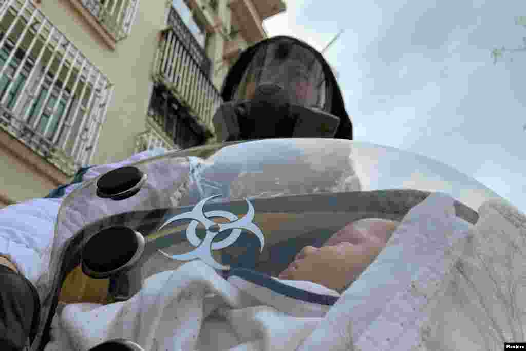 Cao Junjie carries his two-month old infant inside a safety pod he created to protect his baby from the coronavirus, at a residential compound in Shanghai, China.