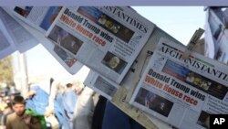 FILE - Newspaper front pages for sale outside a store report on President-elect Donald Trump winning the American election, in Kabul, Afghanistan, Nov. 10, 2016. 