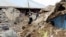 People walk around a destroyed house in Karakocan province of southeastern city Elazig, Turkey, 08 Mar 2010