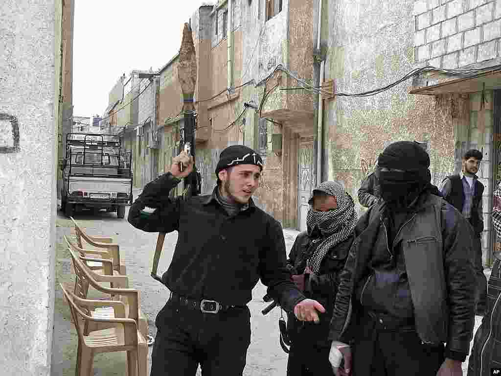 Free Syrian Army fighters are seen in a neighborhood in Damascus. (AP)