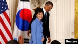 U.S. President Barack Obama and South Korea's President Park Geun-hye depart a joint news conference in the East Room of the White House in Washington, May 7, 2013. 