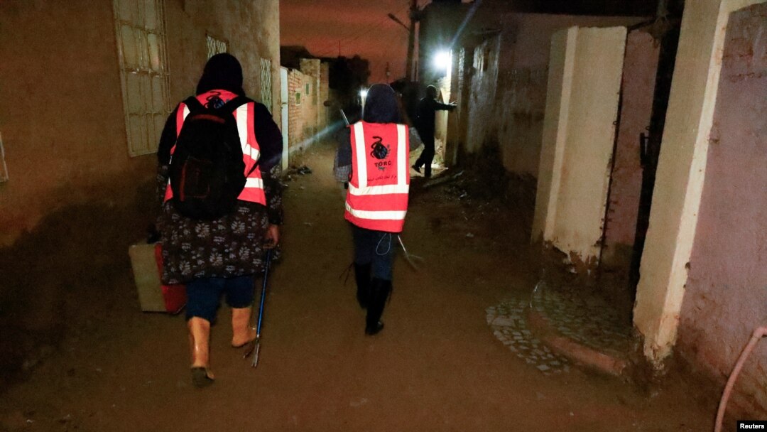 FILE - Director of the Toxic Organism Research Center Dr. Rania Mohamed, and Dr. Manal Siyam search for snakes and scorpions on Tuti Island in Khartoum, Sudan, Sept. 12, 2022.