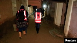 FILE - Director of the Toxic Organism Research Center Dr. Rania Mohamed, and Dr. Manal Siyam hunt  for snakes and scorpions connected  Tuti Island successful  Khartoum, Sudan, Sept. 12, 2022.