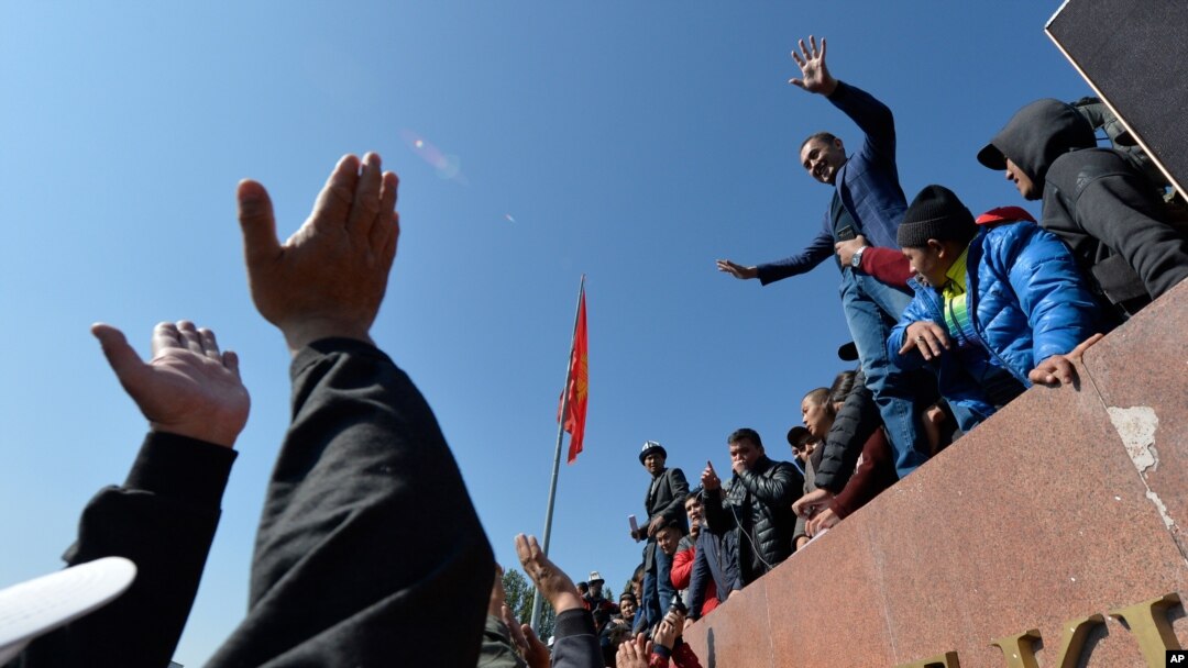 People protest during a rally on the central square in Bishkek, Kyrgyzstan, Oct. 7, 2020. 