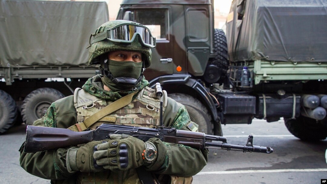 A Russia-backed rebel stands on guard during preparation for an exchange of prisoners in Donetsk, eastern Ukraine, Oct. 29, 2015.