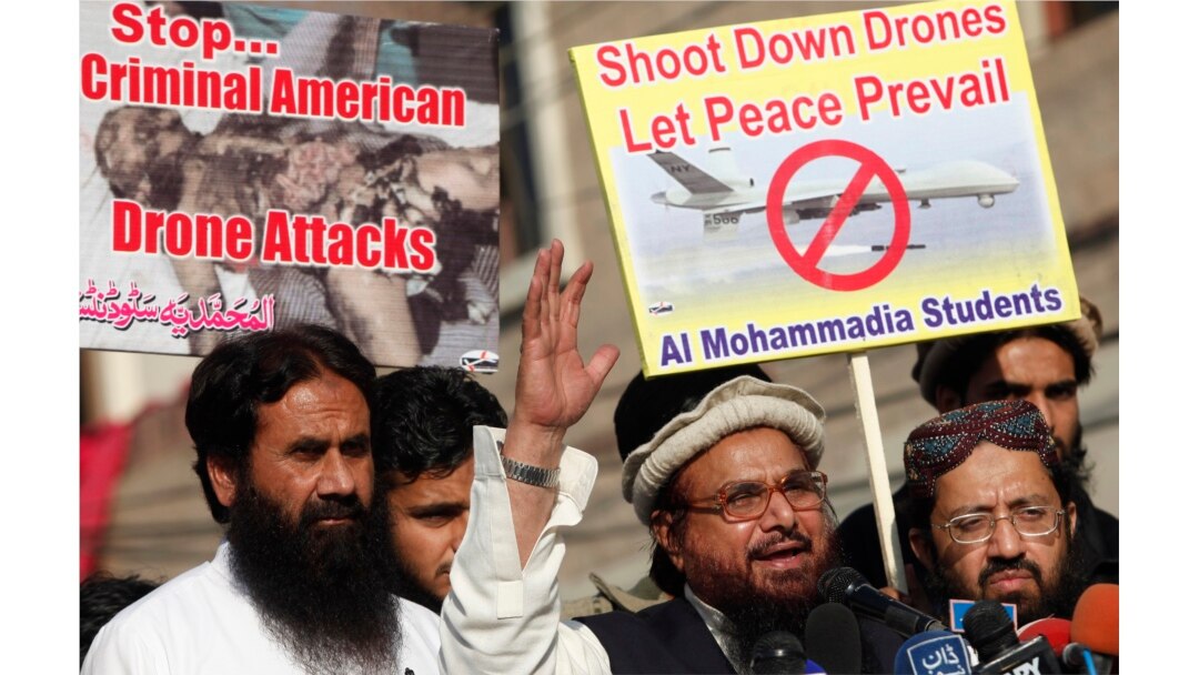 FILE - Hafiz Saeed, head of the Lashkar-e-Taiba group, second from right, addresses supporters during a protest against U.S. drone attacks in the Pakistani tribal region, in Lahore, Nov. 29, 2013.