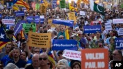 People participate in a demonstration condemning the attacks that killed 15 people last week in Barcelona, Spain, Aug. 26, 2017. The Islamic State group has claimed responsibility for the attacks on Aug. 17-18 in Barcelona and Cambrils that also left more than 120 injured.