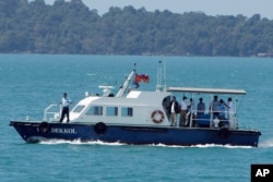 A speed boat transports samples from some passengers who have reported stomachaches or fever, in the Westerdam, anchored off Sihanoukville, Cambodia, Feb. 13, 2020.