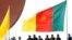 FILE - Cameroonian police stand near a national flag.