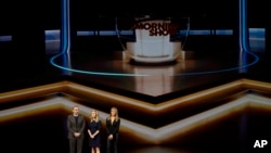 From left, Steve Carell, Reese Witherspoon and Jennifer Aniston speak at the Steve Jobs Theater during an event to announce new Apple products, March 25, 2019, in Cupertino, Calif. 
