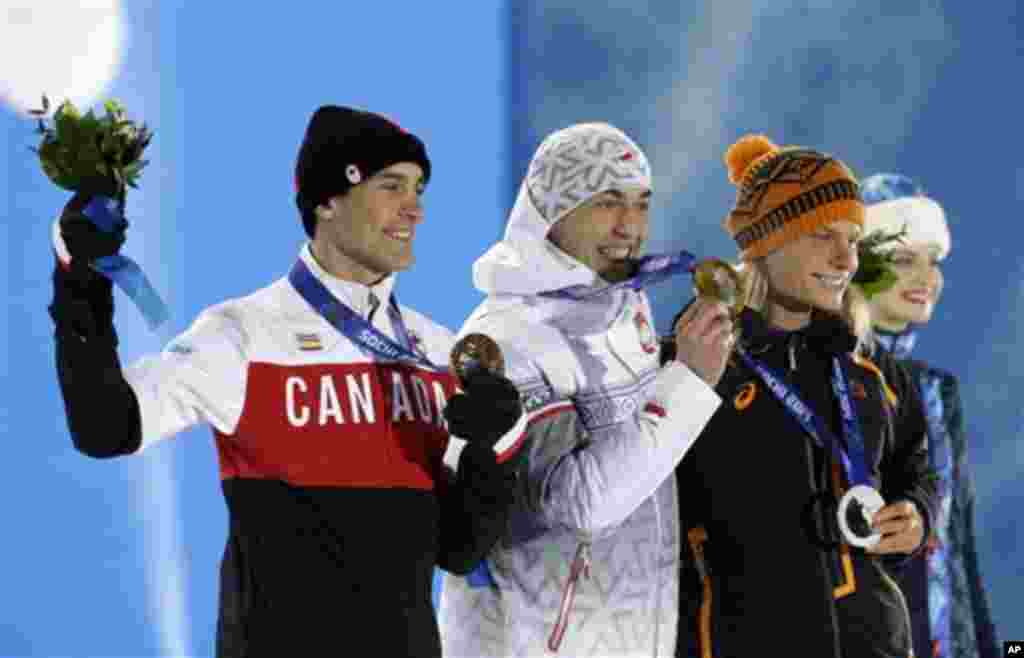 Men's 1,500-meter speedskating medalists, from left, Denny Morrison of Canada, bronze, Zbigniew Brodka of Poland, gold, and Koen Verweij of the Netherlands, silver, pose with their medals at the 2014 Winter Olympics in Sochi, Russia, Sunday, Feb. 16, 2014