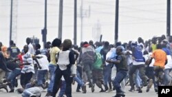 Troops loyal to former president Laurent Gbagbo try to disperse supporters of Alassane Ouattara in the popular Aboboa district of Abidjan, 16 Dec 2010