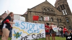 West Virginia University students lead a protest against cuts to programs in world languages, creative writing and more amid a $45 million budget deficit outside Stewart Hall in Morgantown, W.Va., on Monday, Aug. 21, 2023. (AP Photo/Leah Willingham)