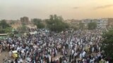 Sudanese people celebrate in the streets of Khartoum after ruling generals and protest leaders announced they have reached an agreement on the disputed issue of a new governing body on July 5, 2019. 