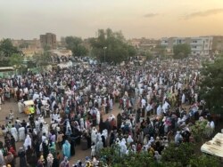 Sudanese people celebrate in the streets of Khartoum after ruling generals and protest leaders announced they have reached an agreement on the disputed issue of a new governing body on July 5, 2019.