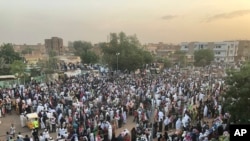 Sudanese people celebrate in the streets of Khartoum after ruling generals and protest leaders announced they have reached an agreement on the disputed issue of a new governing body on July 5, 2019. 