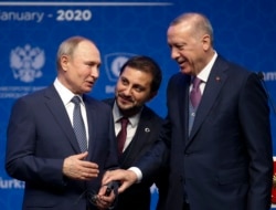 Turkey's President Recep Tayyip Erdogan, right and Russia's President Vladimir Putin, left, talk after they symbolically open a valve during a ceremony in Istanbul for the inauguration of the TurkStream pipeline, Wednesday, Jan. 8, 2020.
