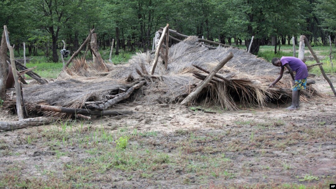 A young boy shows a hut that was destroyed by floods in Tsholostho, about 200 kilometers north of Bulawayo, March 4, 2017.